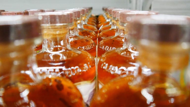 Close-up of whiskey bottle production line Close-up of whiskey bottle production line